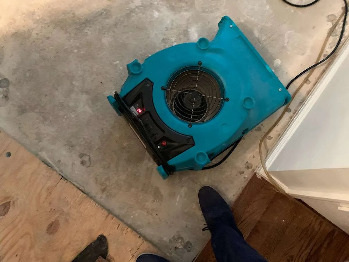 Air mover drying subfloor during Leak Detection & Repair in Whispering Pines